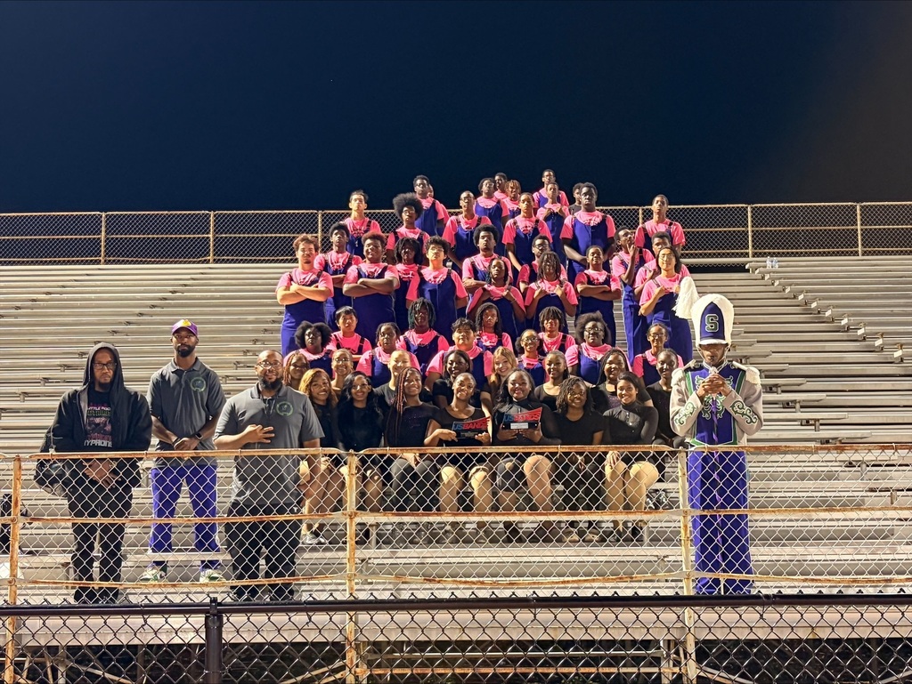 Southwest Band members Band director Holloway, Asst Band director Corley, Drumline leader Wilson, Majorette front row, Gems wearing black and red front row, waering black flagline, marching band of 60  