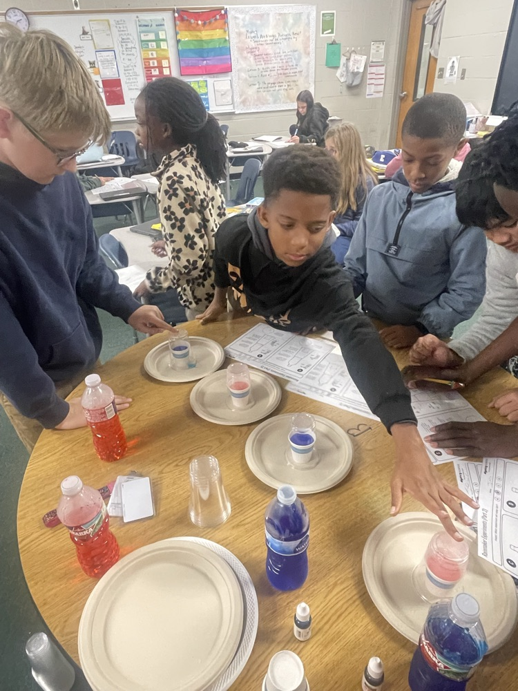 5th grade science made a model to explain how water cycles from the weather’s surface to the atmosphere and back again. By testing different temperatures for the “ocean” and “sky,” we observed evaporation and condensation, making “rain!” 