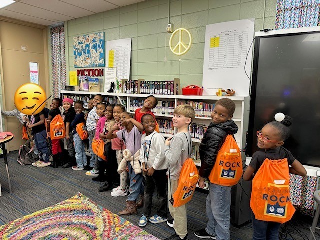 Students in line with backpacks and books