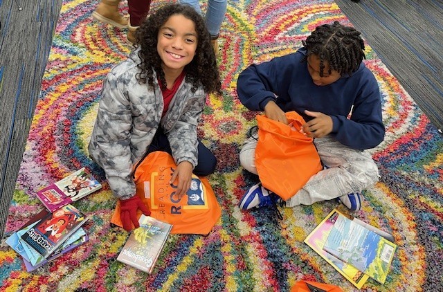 Students on the rug with their book choices