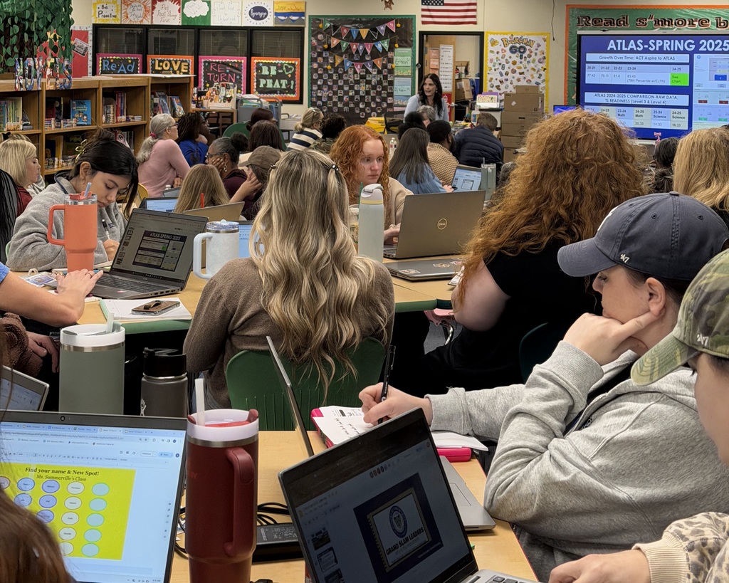 Image of teachers working in the library.