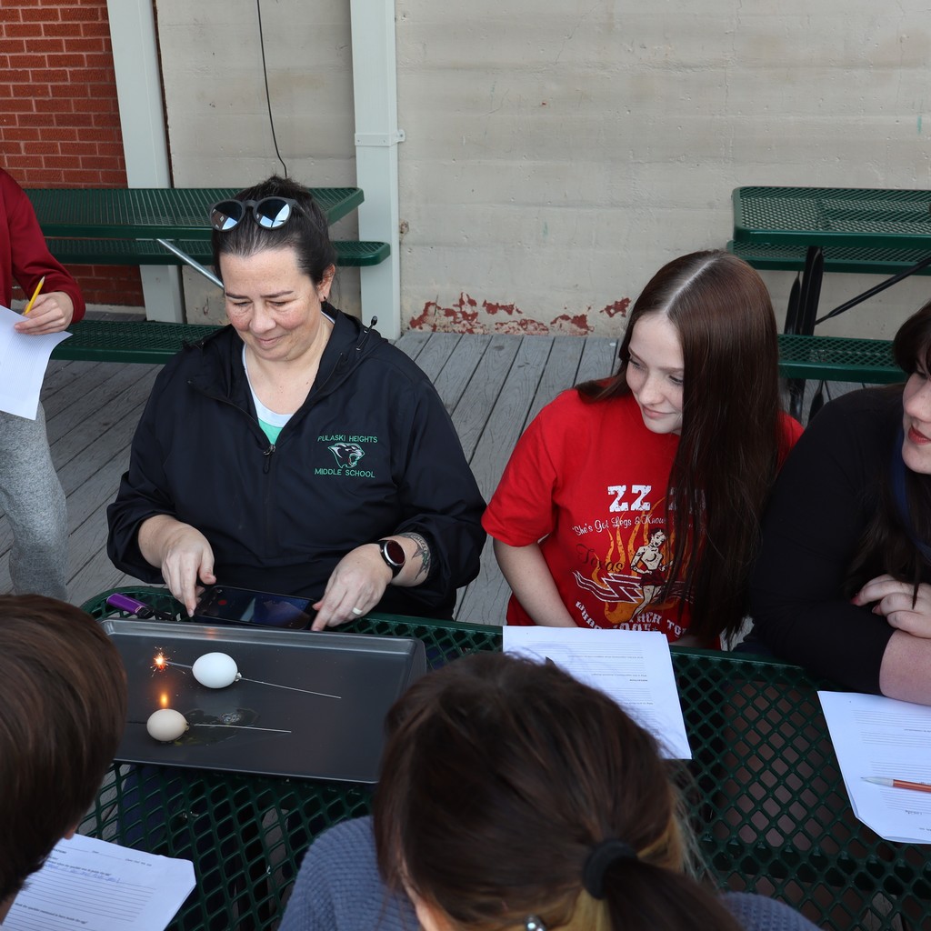 Students watching a sparkler and egg experiment.