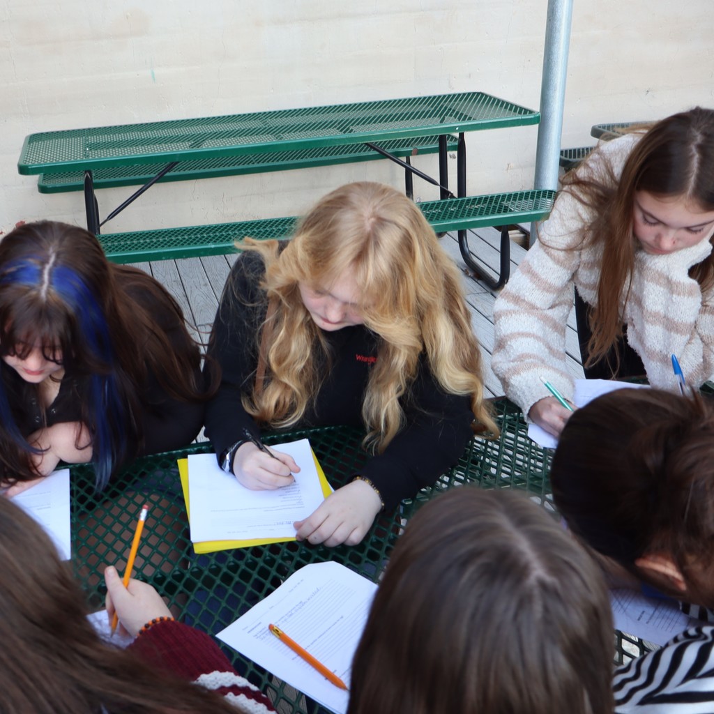 Students watching a sparkler and egg experiment.
