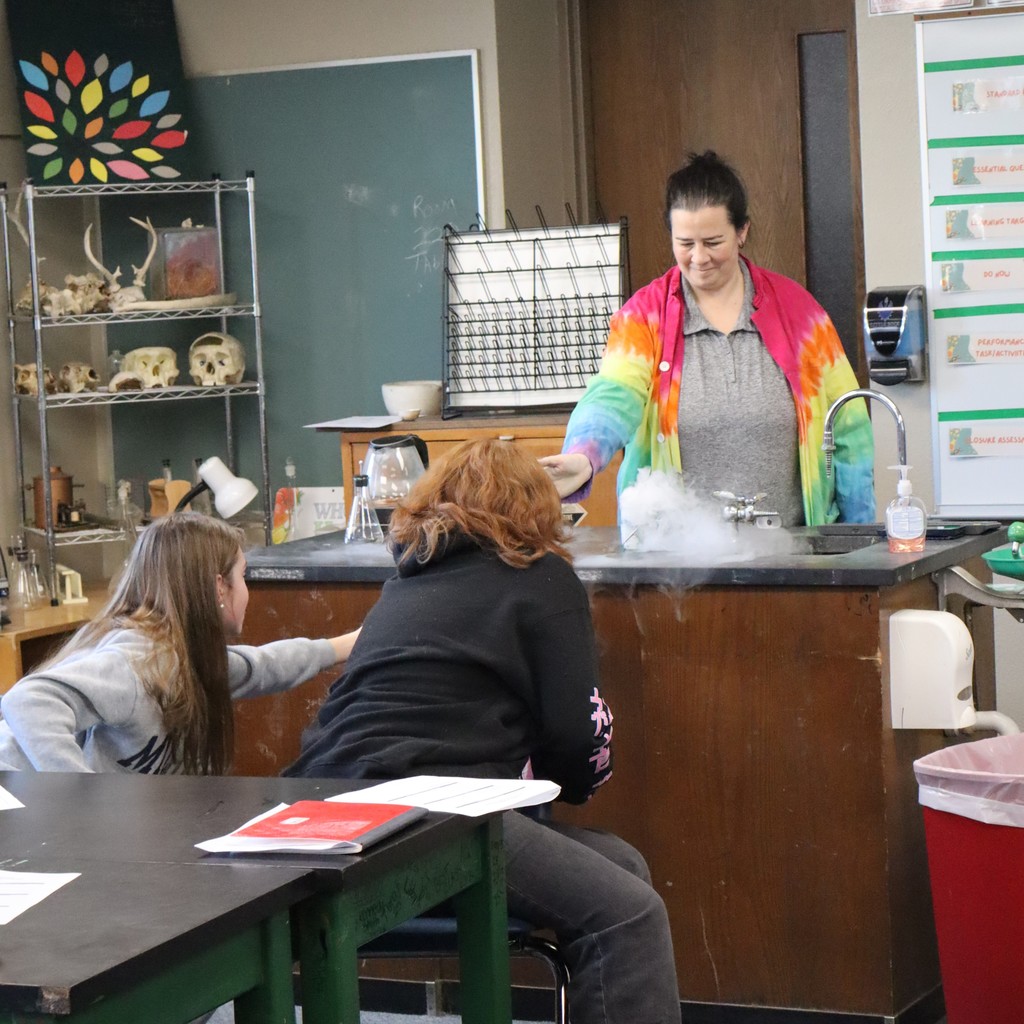 Students observing a chemical reaction with dry ice