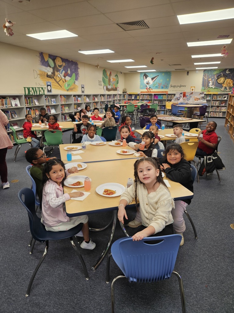 Students enjoying a pizza party after returning to the school.
