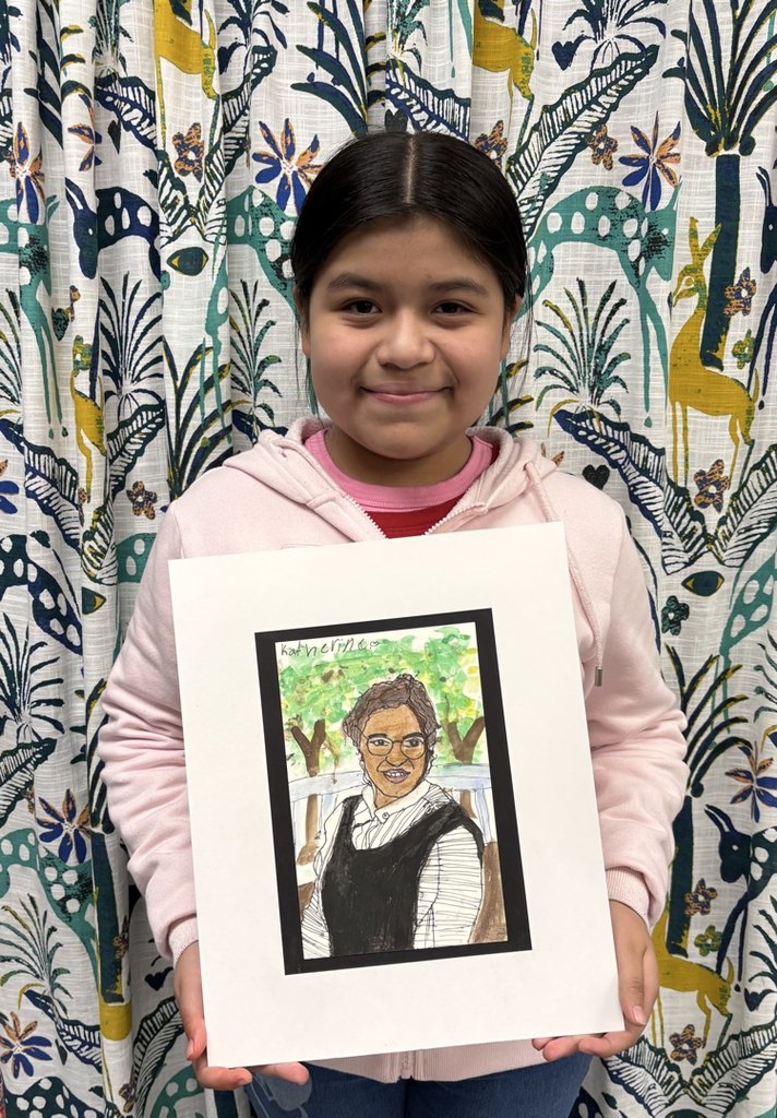 child holding artwork