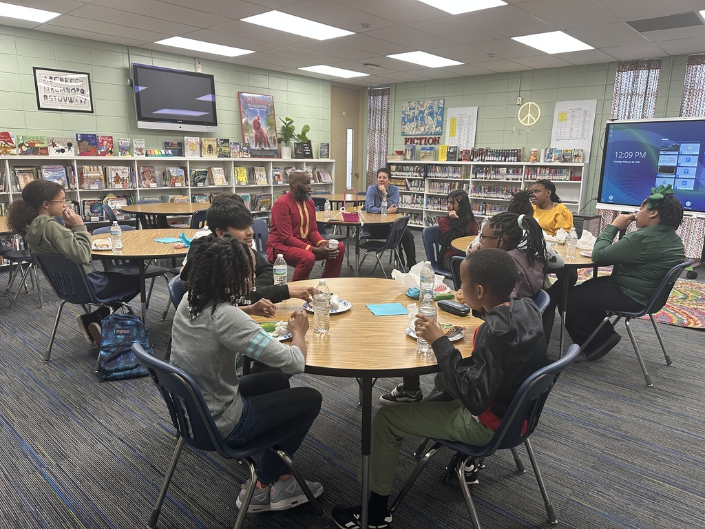 5th graders eating lunch with Dr. Wright
