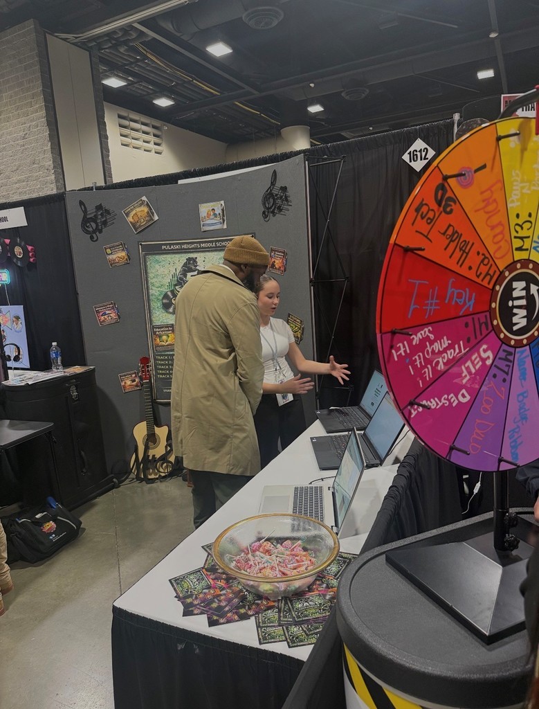 A student explaining a project to Dr. Wright at EAST Conference.