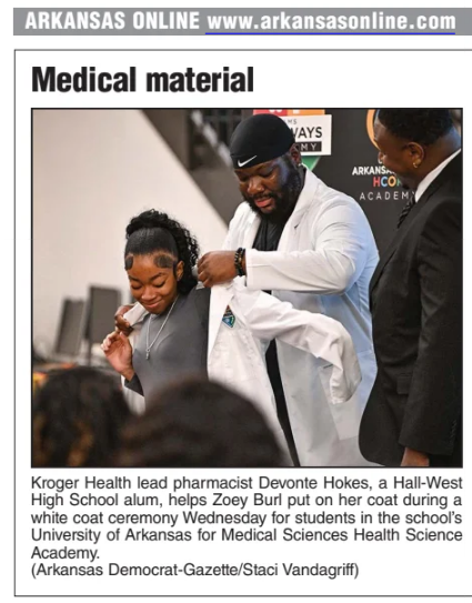 Student receiving white coat.