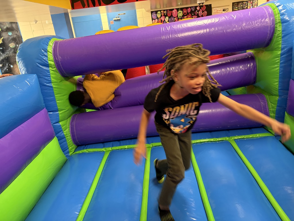 a student running in the inflatable