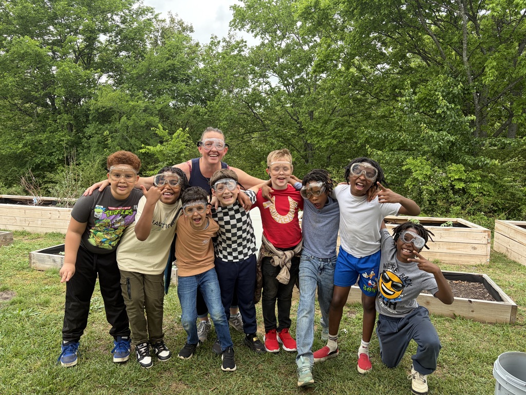 3rd graders and their teacher with safety goggles on