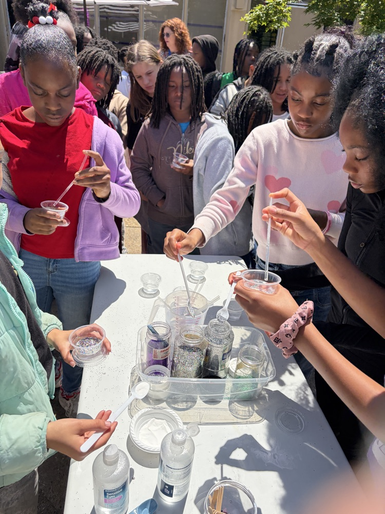 students putting their ingredients together to make slime