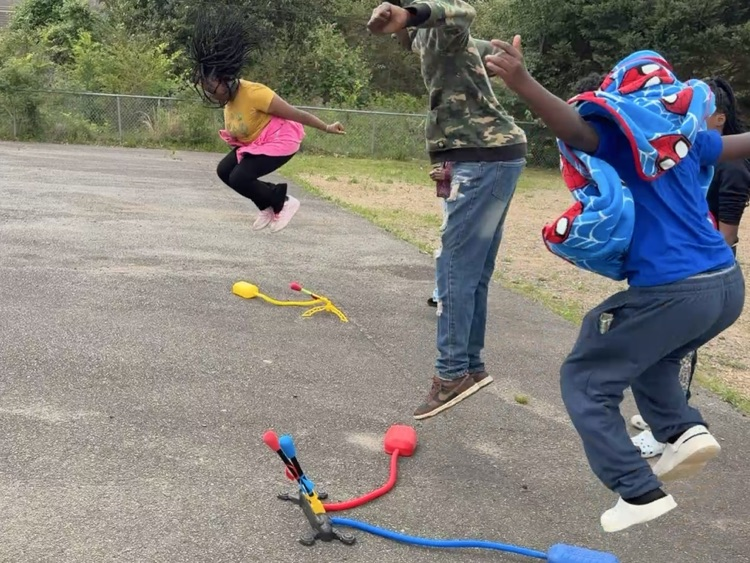 students playing with stomp rockets