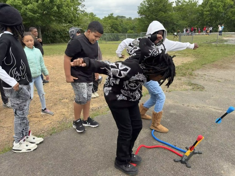 students playing with stomp rockets
