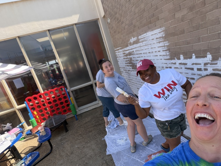 staff, students and community members paint a mural at McDermott