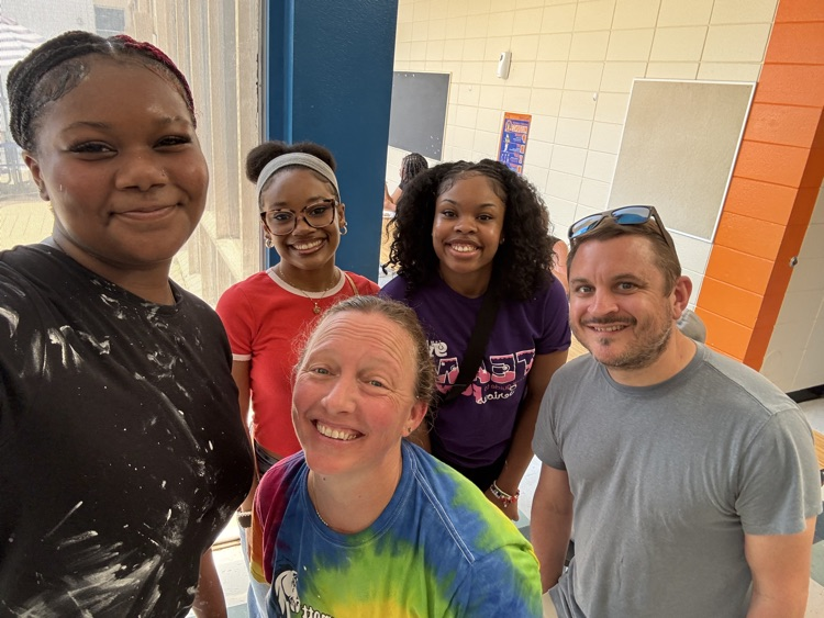 staff, students and community members paint a mural at McDermott