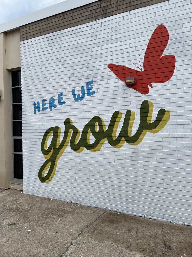 staff, students and community members paint a mural at McDermott