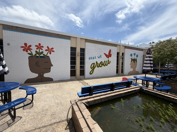 a courtyard with a new mural on the walls