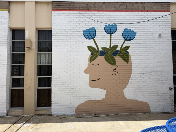 a courtyard with a new mural on the walls