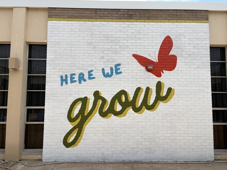 a courtyard with a new mural on the walls