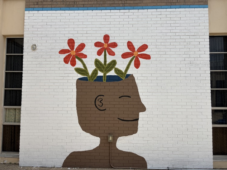a courtyard with a new mural on the walls