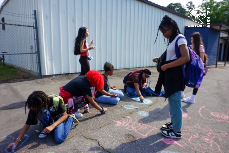 War Eagle students doing sidewalk chalk art on Field Day.