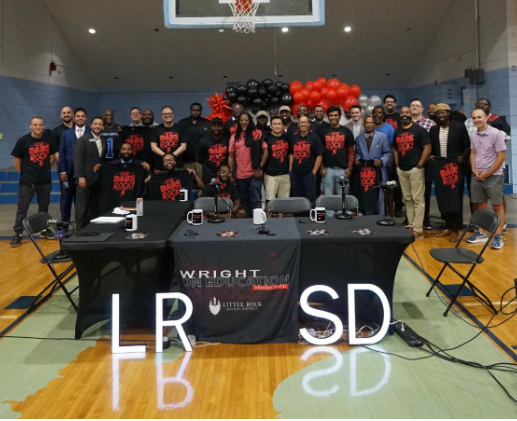 Wide shot of dads and father figures standing for group photo