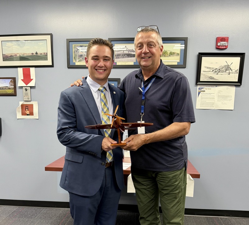 Mr. Lovell presents Dr. Moyer with a Thunderbolt Plane