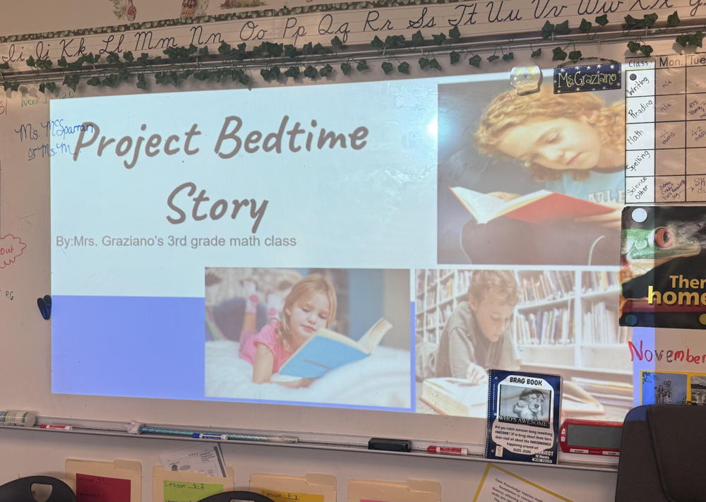 Projector screen displaying "Project Bedtime Story" by Mrs. Graziano's 3rd grade math class with photos of children reading.