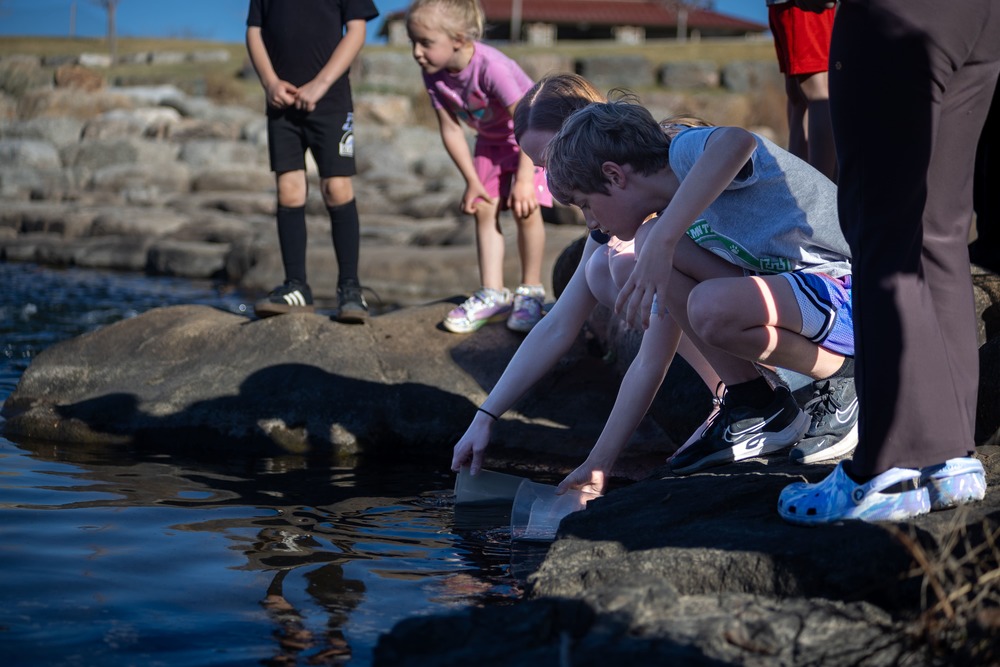 Community and students members gather at the south Platte to release trout