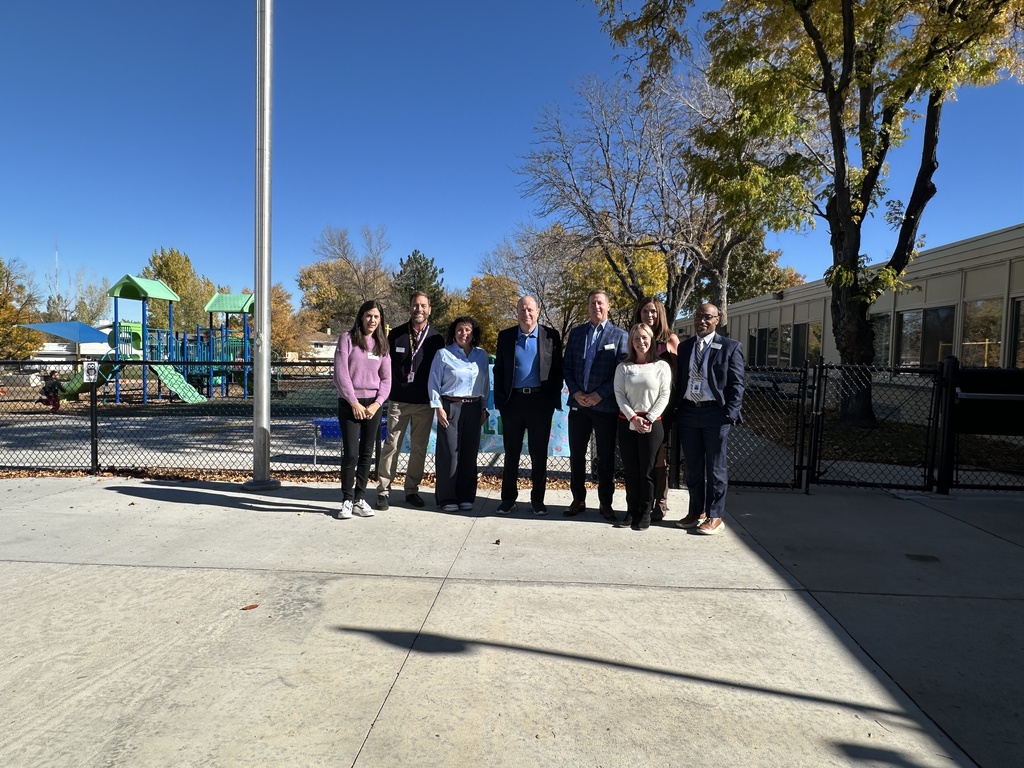 Governor Jared Polis stands with school and district leaders at The Village ECE.