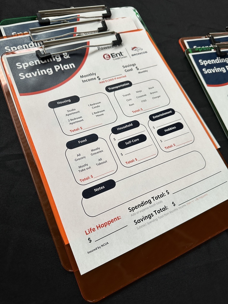 Close-up of a spending and saving plan worksheet on a clipboard, powered by Ent Credit Union and the Broncos.