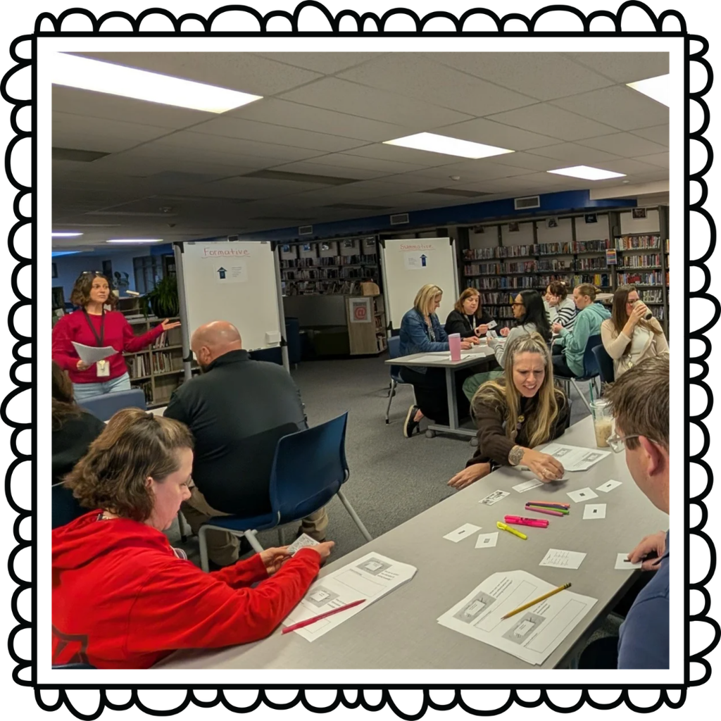 Teacher lecutring in the front of the classroom while other teachers learn