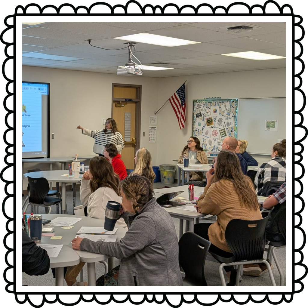 Teacher lecutring in the front of the classroom while other teachers learn