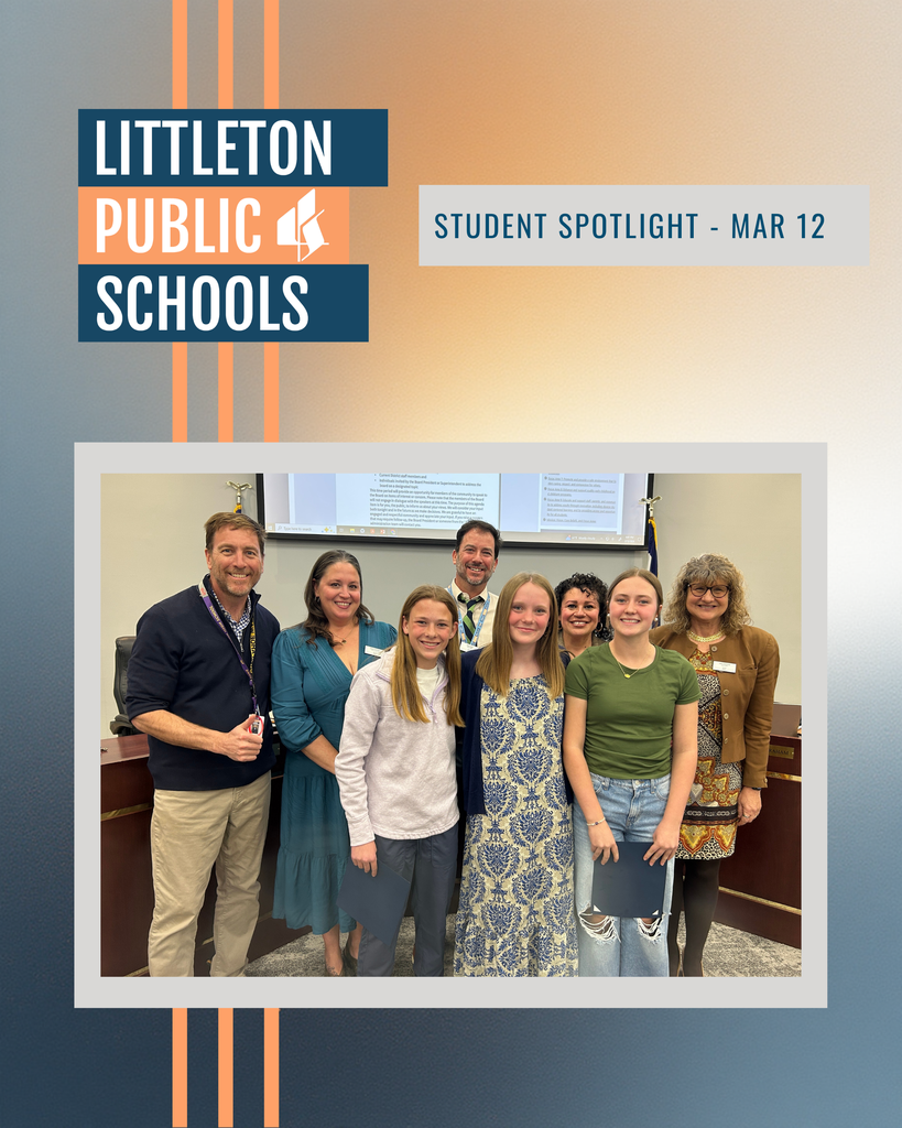 Three female middle school students stand with the Board of Education during the Student Spotlight segment of the Board meeting.