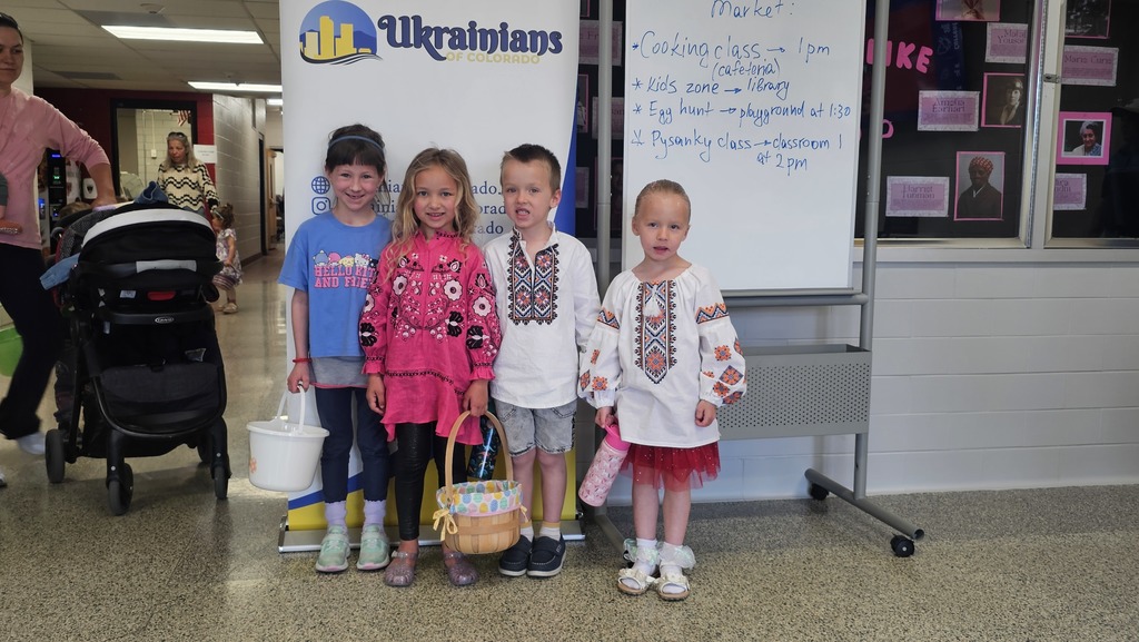 photograph of four young children attending an Easter egg hunt