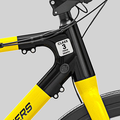 Alt Text: Close-up of a yellow and black bike frame featuring a sticker that reads Class 3, 750W, 28MPH.