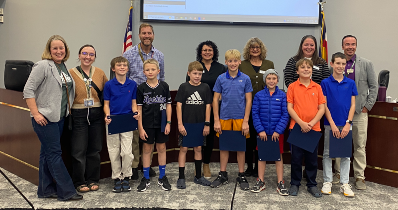 Students from Ford, along with school administrators, stand with the Board of Education in the LPS Boardroom.