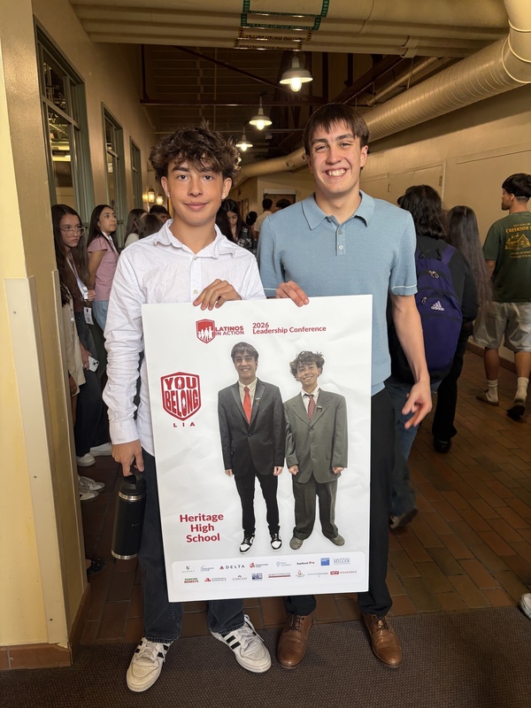 Two Heritage High students hold a "You Belong" poster at the 2026 Latinos In Action Leadership Conference.
