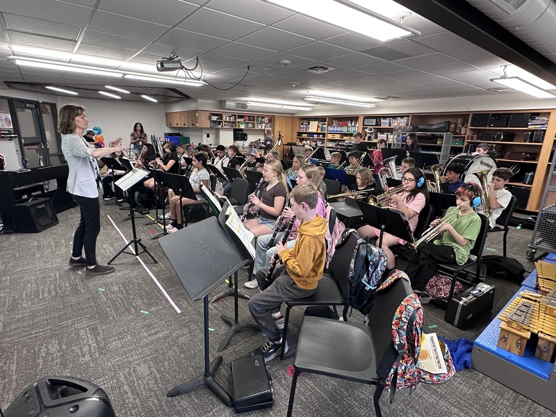 A female teacher conducts during band class at Centennial Elementary School.