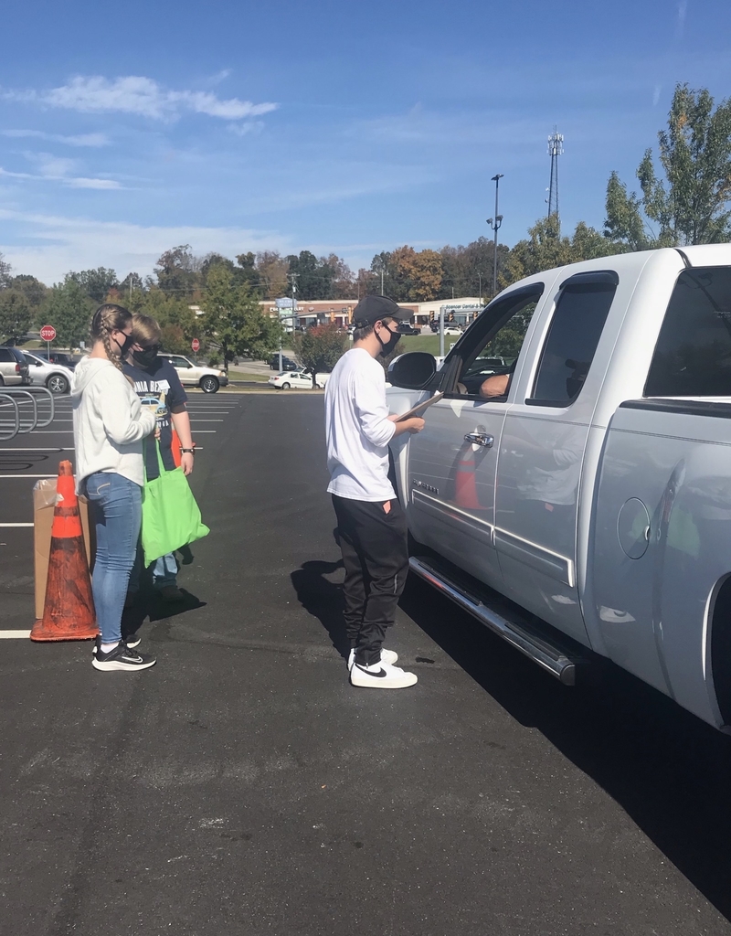 Honor Society members ask questions and help take back prescription drugs at event.