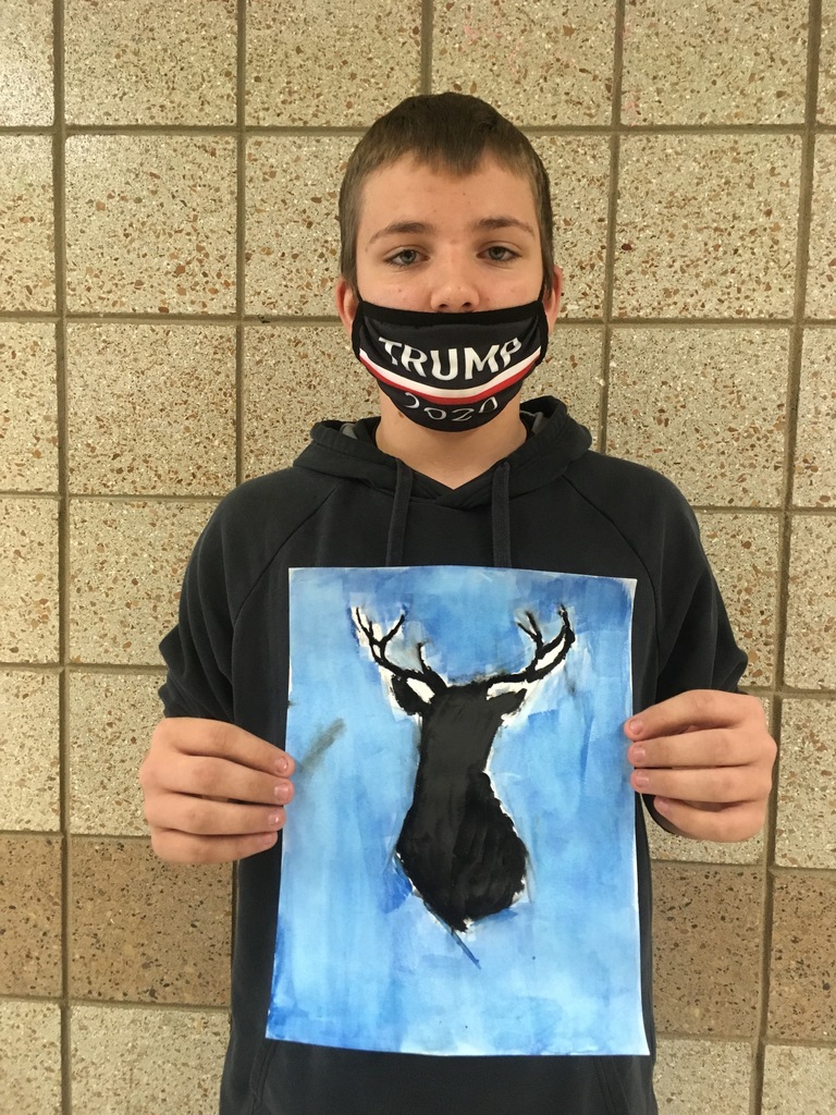 male student holding his painting of a deer