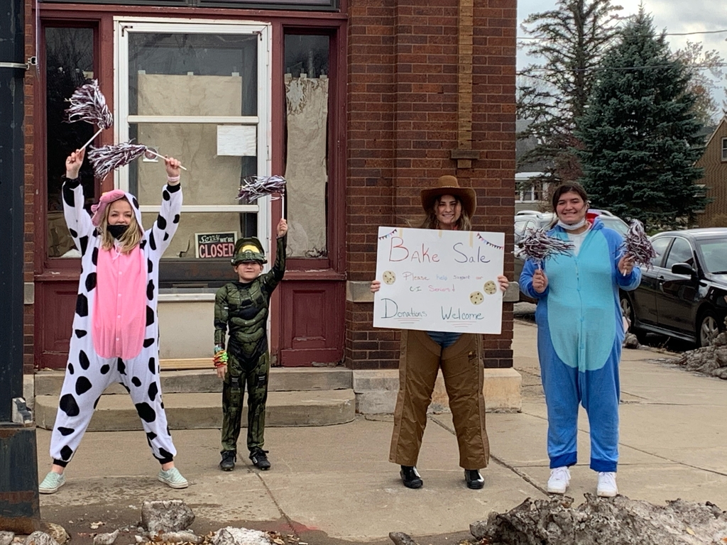 3 female students and a male student with signs