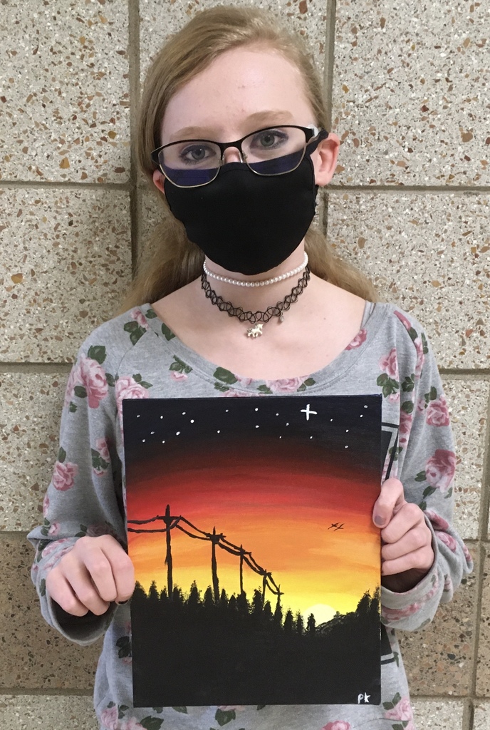 female student with a sunset painting