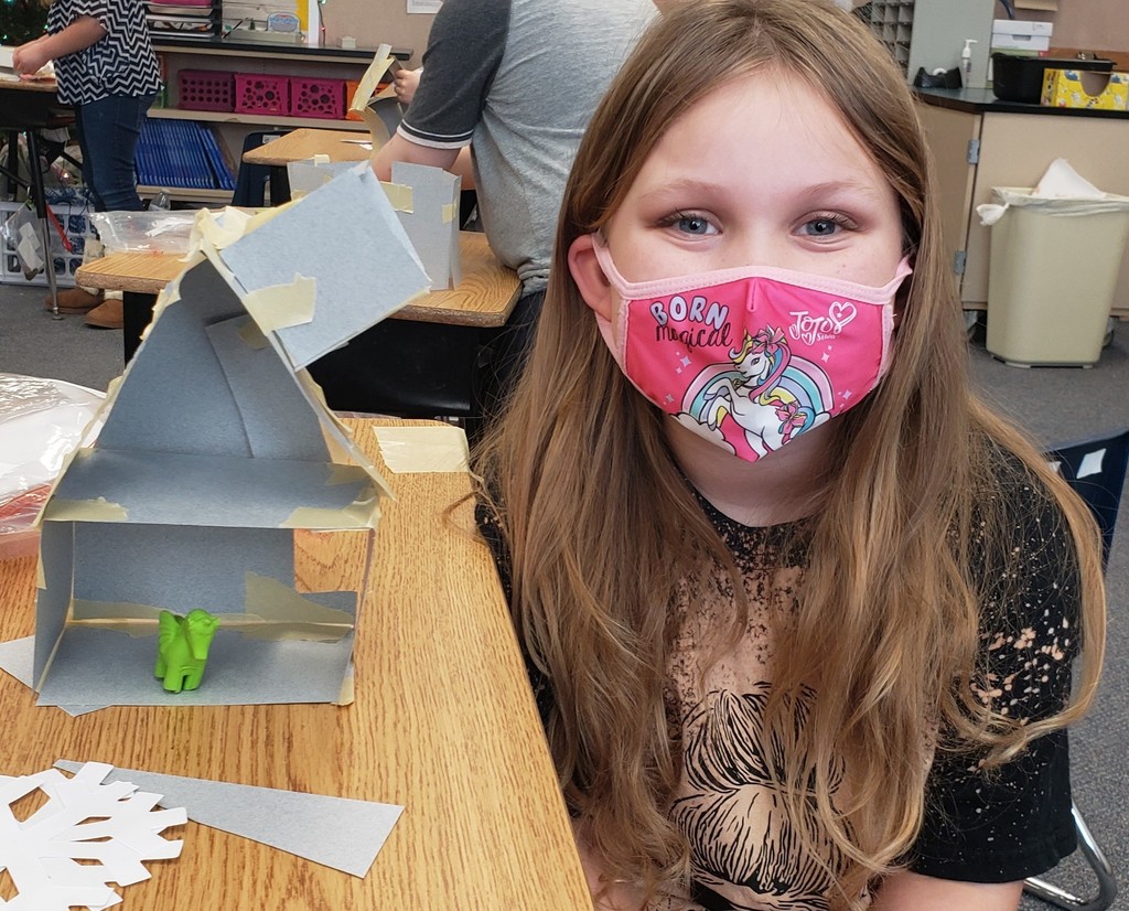 Girl posing with her eraser house