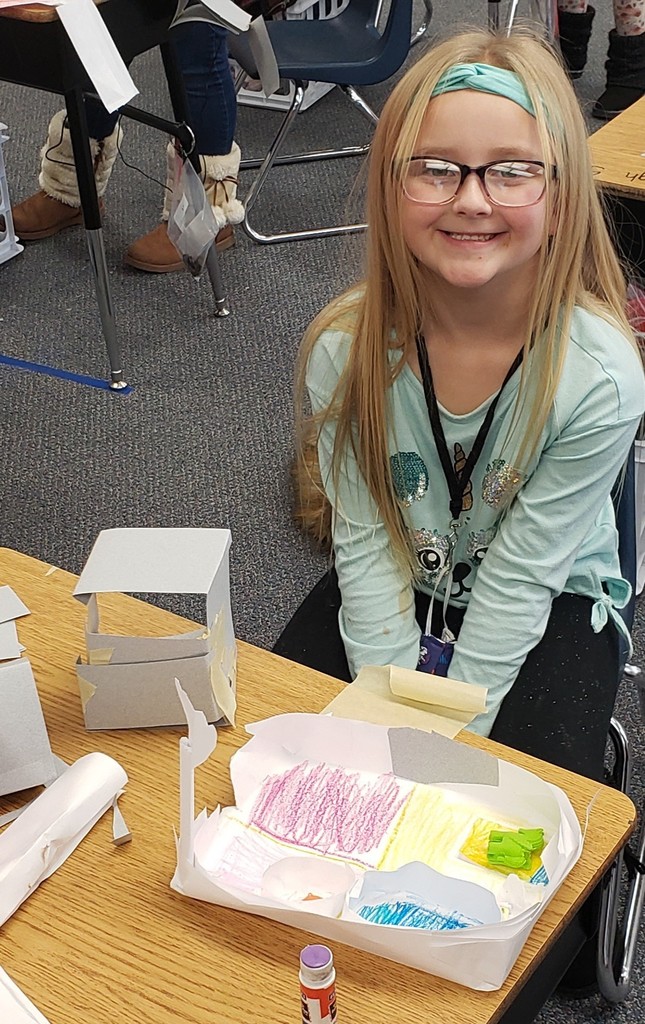 Smiling girl with eraser house