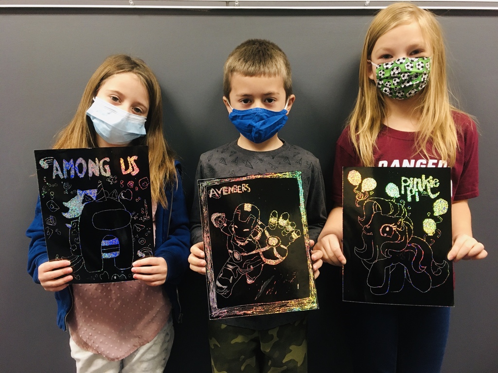 male and 2 female students holding scratch art