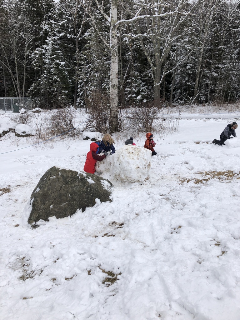Children making snow boulders