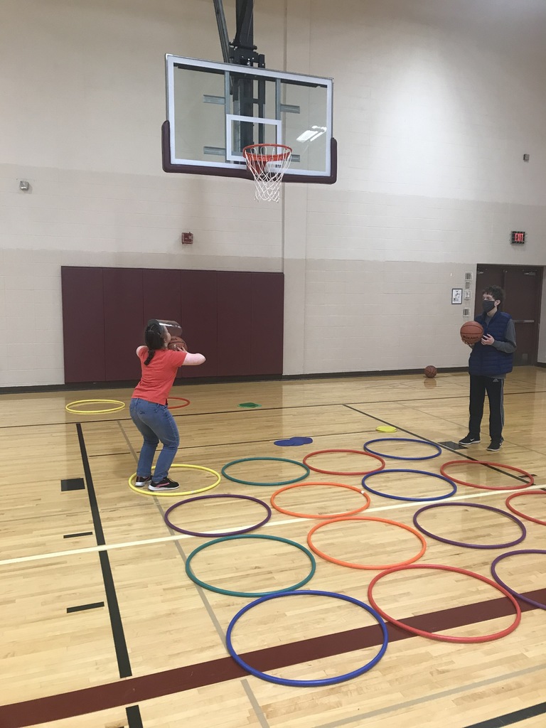 female shooting a basketball