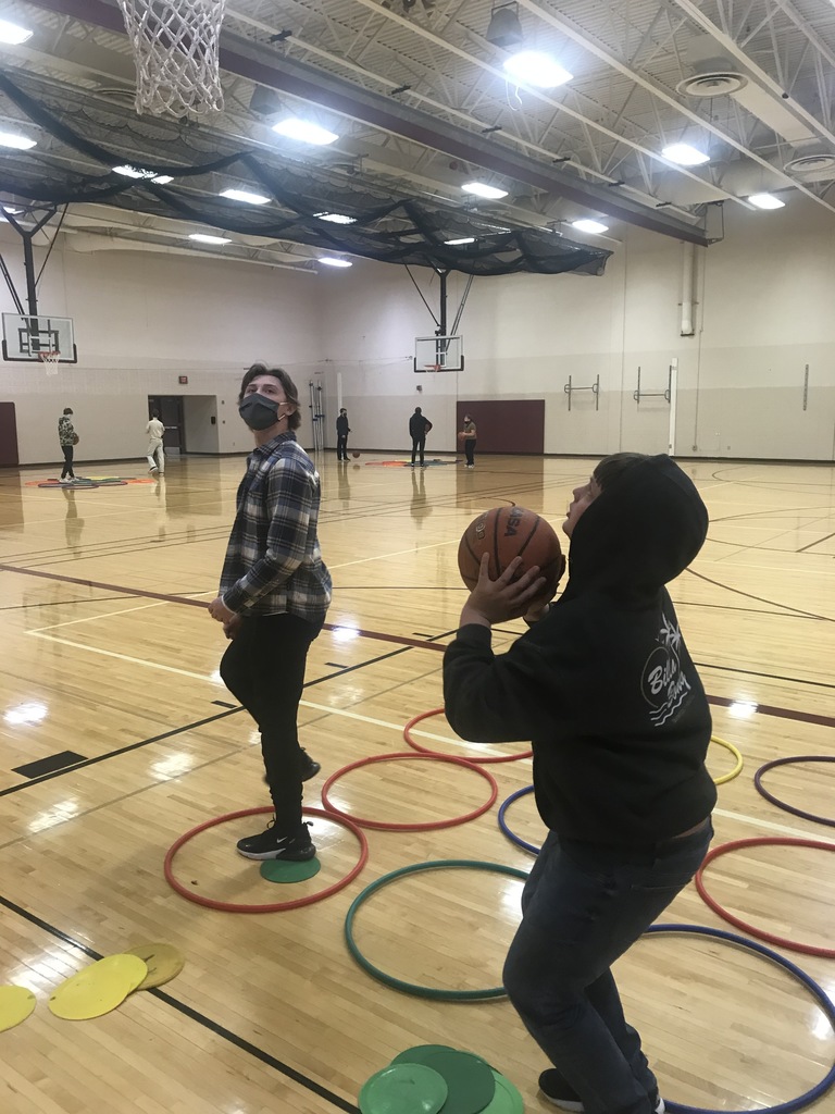 two male students one holding a basketball